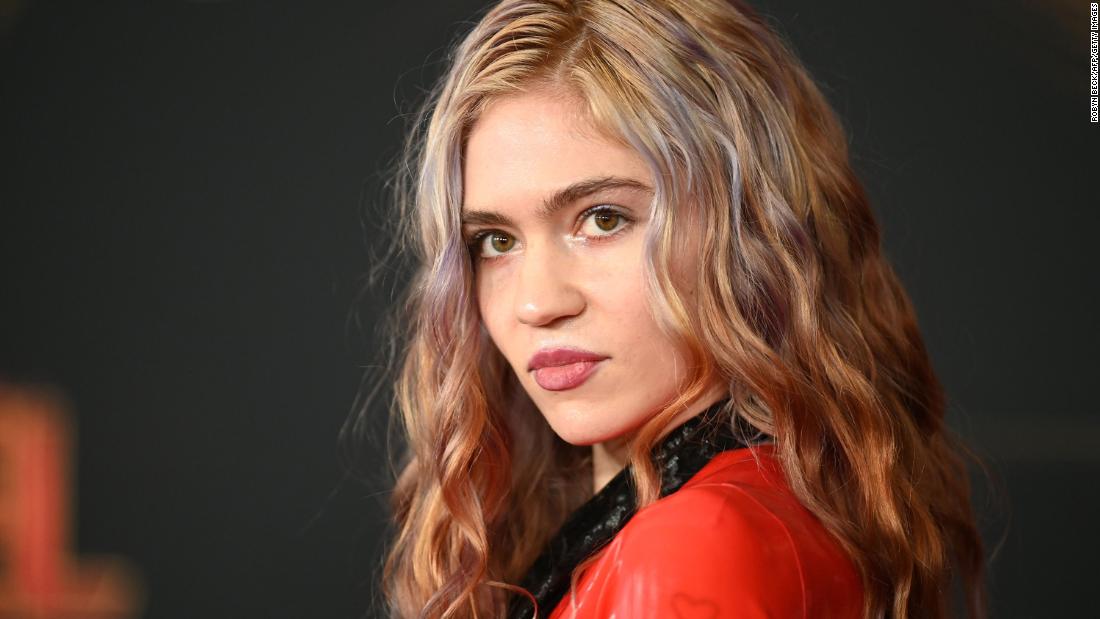 Grimes shows off tattoo of 'beautiful alien scars' across her back - CNN