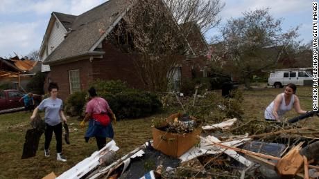 Volunteers clean up debris on March 26, following a tornado that hit the Eagle Point community south of Birmingham, Alabama. 