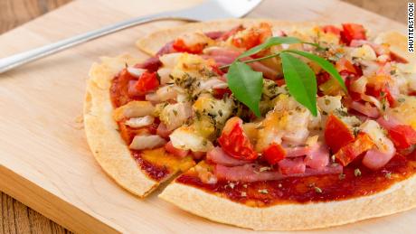 Make a personal pan pizza with  a tortilla topped mozzarella, pepper, and basil.