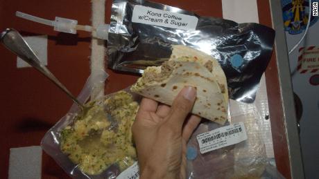 An Expedition 32 crew member enjoys a stuffed tortilla on the space station in 2012.