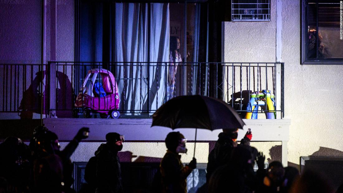 People confront law enforcement Tuesday outside an apartment complex near the Brooklyn Center Police Department.