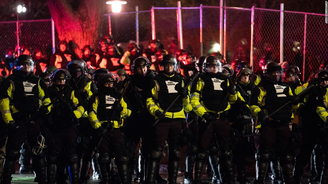 Authorities advance on demonstrators gathered outside the Brooklyn Center Police Department on Tuesday.