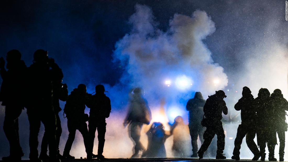 Protesters and police clash for a third night in a Minneapolis suburb as prosecutors weigh charges against officer