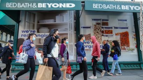 People wearing face masks walk past the Bed Bath &amp; Beyond store. Bed Bath &amp; Beyond has announced plans to permanently close about 200 stores over the next two years. This announcement appears to be the first iteration of that plan, report says.