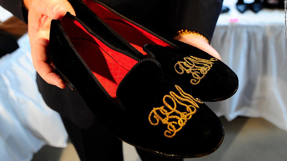 A pair of slippers that belonged to Madoff, with his embroidered initials, are displayed before an auction in November 2010.