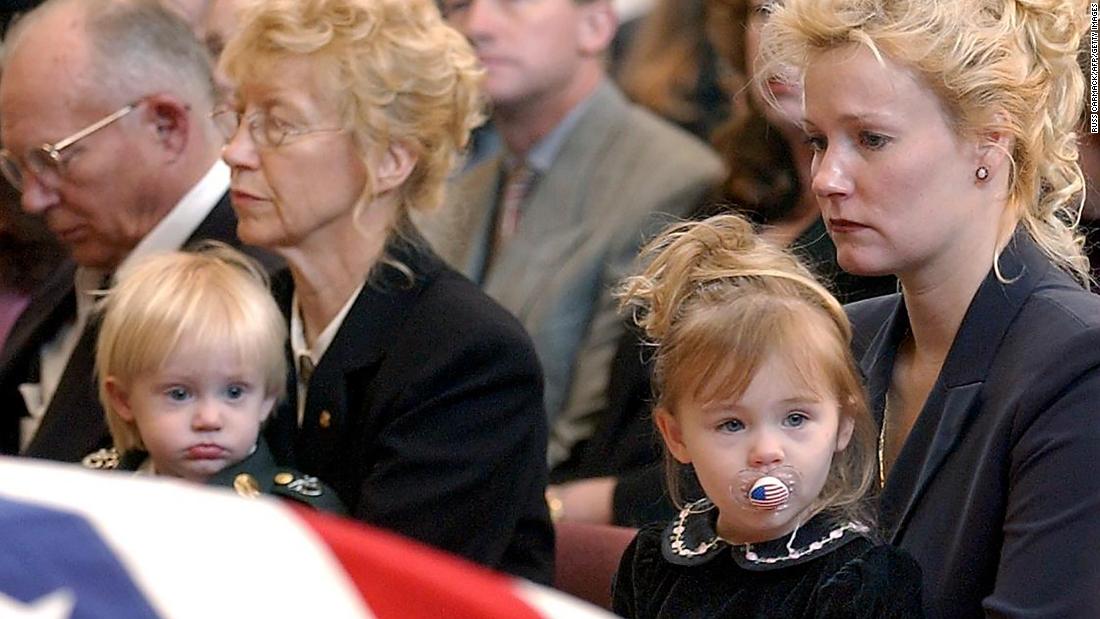 Renae Chapman holds her 2-year-old daughter, Amanda, during the funeral service for her husband, Army Sgt. 1st Class Nathan R. Chapman, in Fort Lewis, Washington, in January 2002. He was the first US soldier to be killed by enemy fire during the war in Afghanistan.