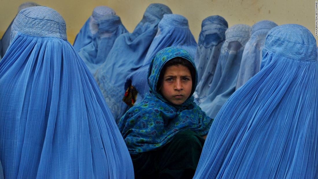 Women wait in line to be treated at a health clinic in Kalakan, Afghanistan, in February 2003.