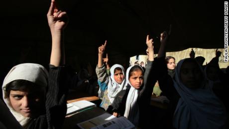 Afghan girls raise their hands during English class in Kabul, Afghanistan in 2006. The Taliban have announced new restrictions on girls&#39; education.