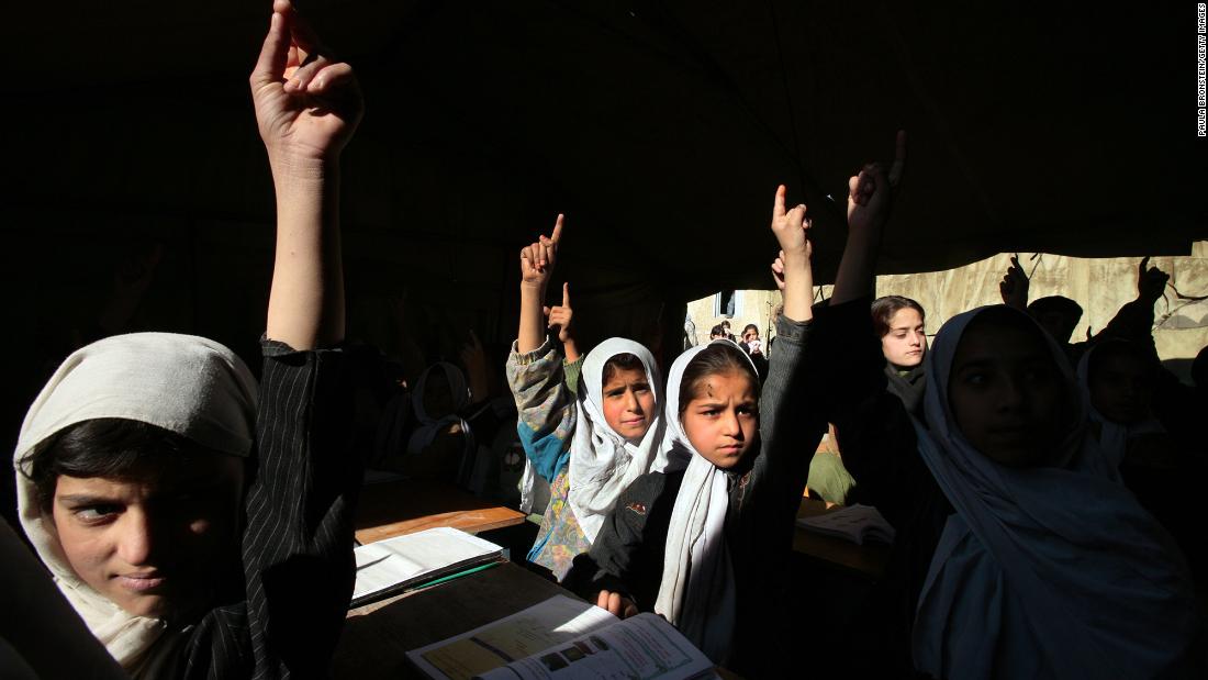 Girls at the Bibi Mahroo High School raise their hands during an English class in Kabul in November 2006. After the fall of the Taliban, millions of Afghan girls &lt;a href=&quot;https://www.cnn.com/2012/09/26/world/asia/cnnheroes-afghan-schoolgirls&quot; target=&quot;_blank&quot;&gt;were able to attend school&lt;/a&gt; and get the education that their mothers couldn&#39;t.