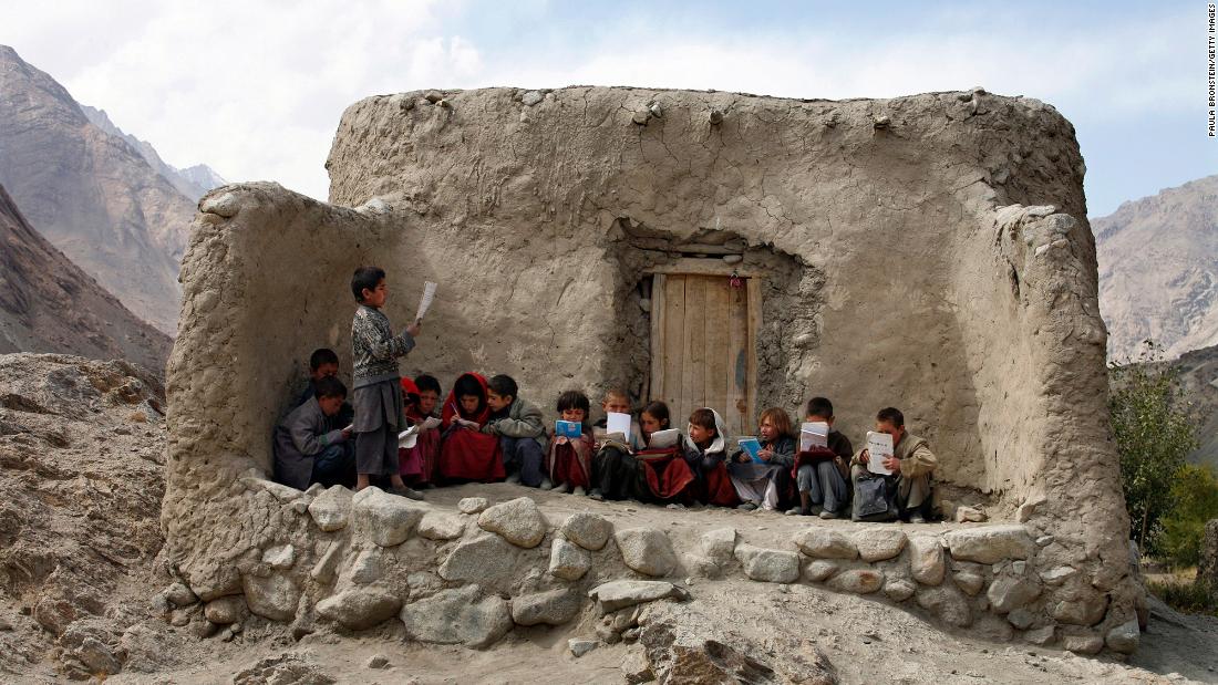 Afghan students recite Islamic prayers at an outdoor classroom in the remote Wakhan Corridor in September 2007.