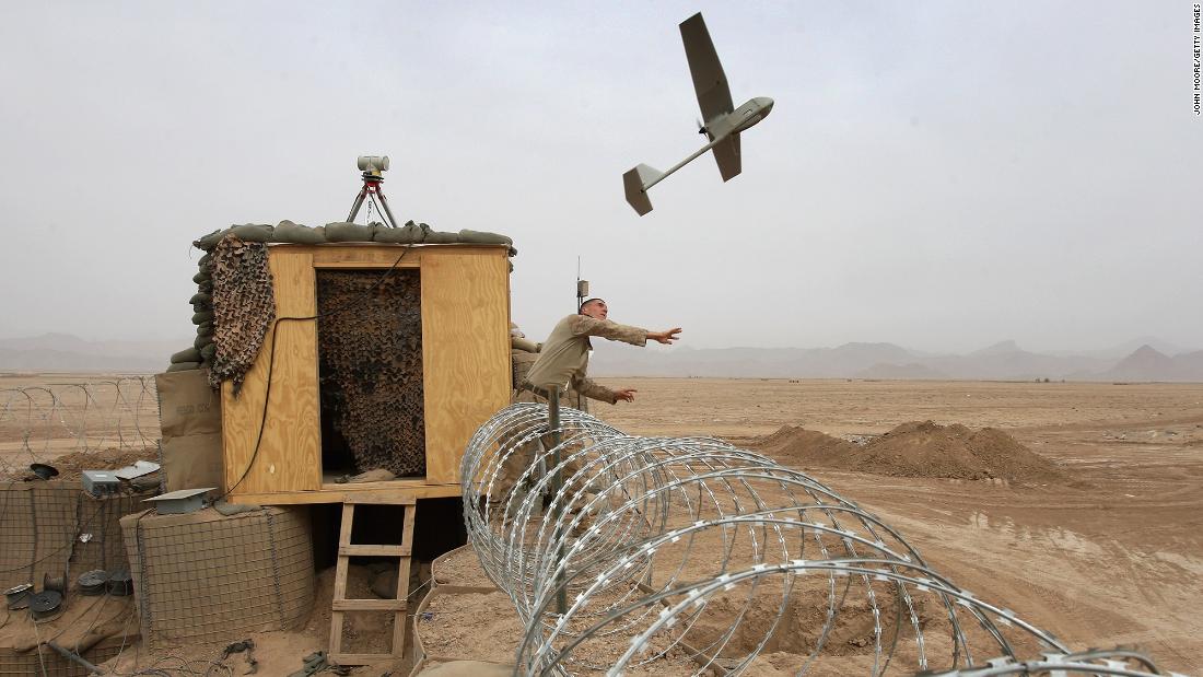 US Marine Sgt. Nicholas Bender launches a Raven surveillance drone near the remote village of Baqwa, Afghanistan, in March 2009.