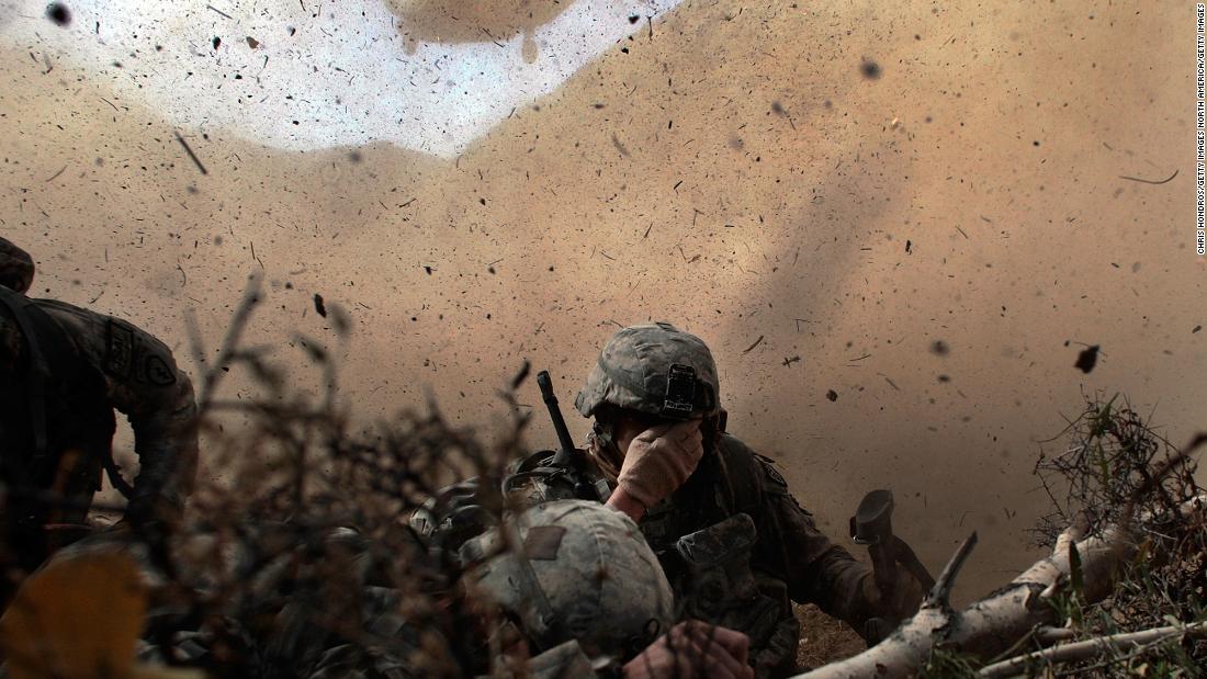 US soldiers shield their eyes from the rotor wash of a Chinook helicopter as they are picked up from a mission in Afghanistan's Paktika province in October 2009.