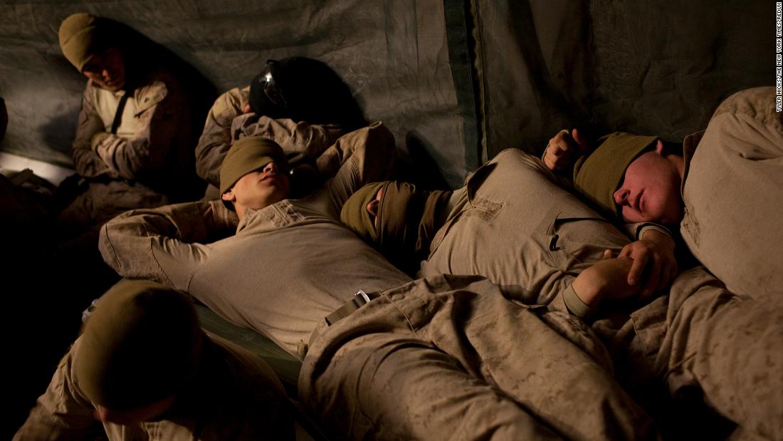 Troops rest at an airfield in Afghanistan's Helmand province in February 2010.