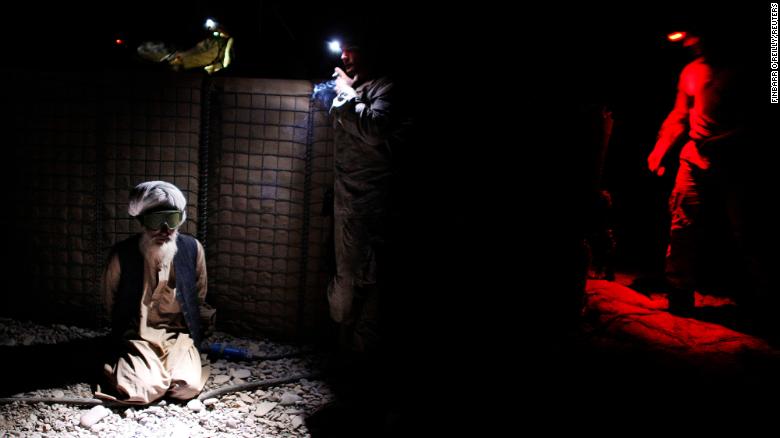 An Afghan man is detained by US Marines after they battled Taliban insurgents in Afghanistan&#39;s Helmand province in November 2010.