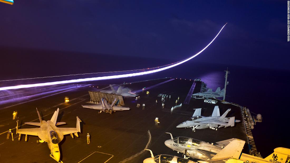 In this long-exposure photo, a jet takes off from the flight deck of the USS John C. Stennis, an aircraft carrier that was in the northern Arabian Sea in January 2012.