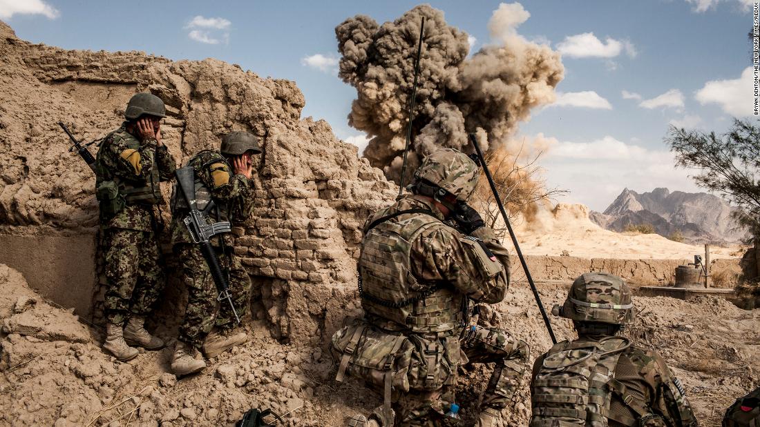 Afghan soldiers, left, and American troops blow up a Taliban firing position in the Afghan village of Layadira in February 2013.