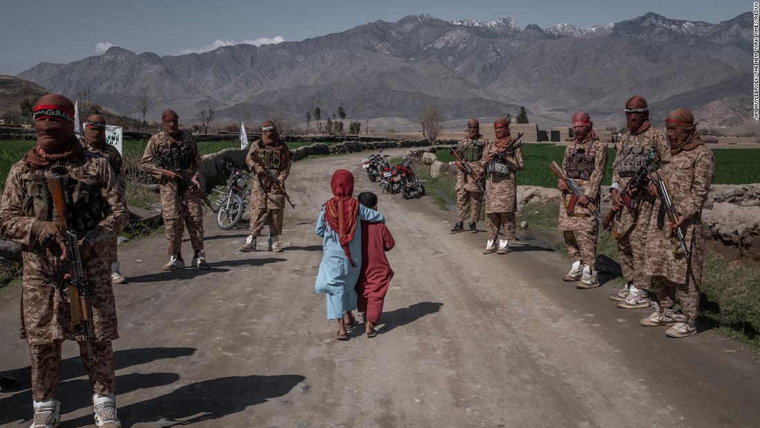 Two children pass members of a Taliban Red Unit in Afghanistan&#39;s Laghman province in March 2020. A month earlier, the United States and the Taliban &lt;a href=&quot;https://www.cnn.com/2020/02/29/politics/us-taliban-deal-signing/index.html&quot; target=&quot;_blank&quot;&gt;signed a historic agreement.&lt;/a&gt;