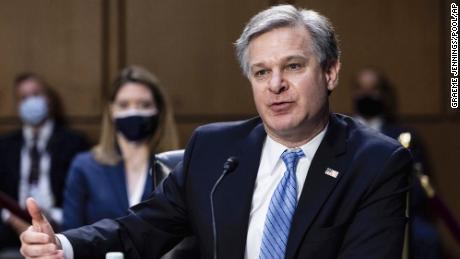 FBI director says bureau is not investigating QAnon conspiracy &#39;in its own right&#39; 