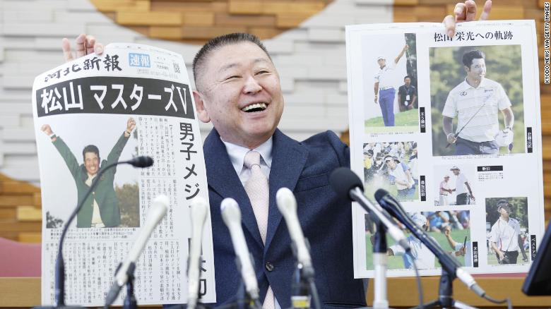 Yasuhiko Abe, who coached golfer Hideki Matsuyama during his Tohoku Fukushi University years, holds special editions of newspapers featuring Matsuyama&#39;s Masters victory. 