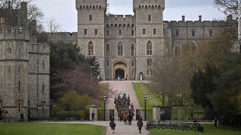 Members of the King&#39;s Troop Royal Horse Artillery ride away from Windsor Castle, west of London, on April 15.