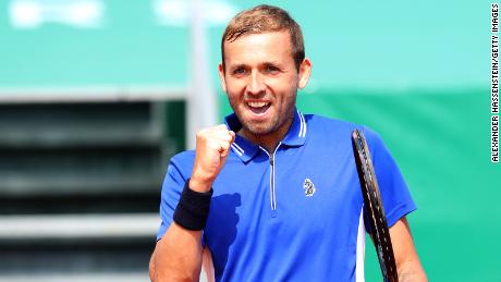 Evans celebrates winning his quarterfinal match against Djokovic.