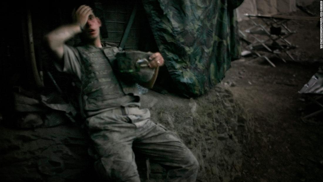 US Army Spc. Brandon Olson sinks onto a bunker embankment in Afghanistan&#39;s Korengal Valley in September 2007. The Korengal Valley was the site of some of the deadliest combat in the region.