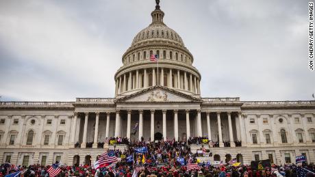 WASHINGTON, DC - JANUARY 06: A large group of pro-Trump protesters stand on the East steps of the Capitol Building after storming its grounds on January 6, 2021 in Washington, DC. A pro-Trump mob stormed the Capitol, breaking windows and clashing with police officers. Trump supporters gathered in the nation&#39;s capital today to protest the ratification of President-elect Joe Biden&#39;s Electoral College victory over President Trump in the 2020 election. 