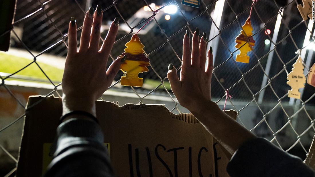 A demonstrator presses their hands against a perimeter security fence outside the Brooklyn Center Police Department. The fence is adorned with car air fresheners symbolic to the shooting death of Daunte Wright. Moments before police fatally shot Wright during a traffic stop Sunday, he called his mother and &lt;a href=&quot;https://www.cnn.com/2021/04/12/us/police-shooting-air-freshener-trnd/index.html&quot; target=&quot;_blank&quot;&gt;told her he&#39;d been pulled over for hanging air fresheners from his rearview mirror.&lt;/a&gt; Minnesota is one of at least several states with laws that prohibit hanging items from a vehicle&#39;s rearview mirror or affixing them to the windshield on the grounds that they could obstruct the driver&#39;s vision. Brooklyn Center Police Chief Tim Gannon told reporters that Wright was originally pulled over for an expired tag and that when officers approached his car, they saw an item hanging from the rearview mirror. Officers ran Wright&#39;s name and found a gross misdemeanor warrant, Gannon said.