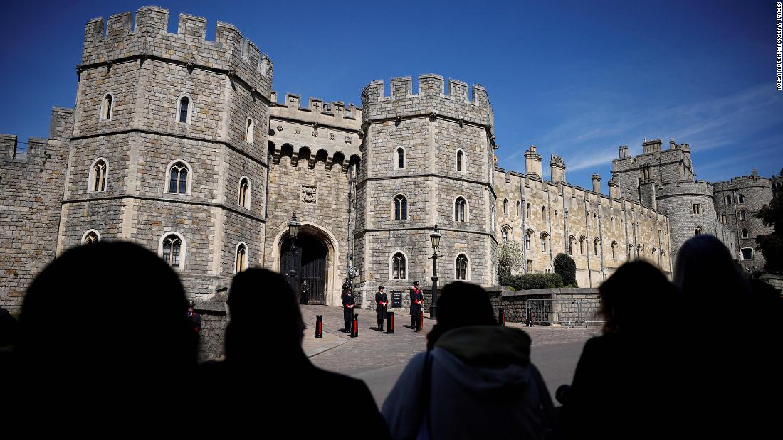 People gather outside Windsor Castle before the funeral.