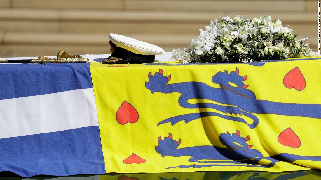 Philip&#39;s coffin, draped with his personal flag, had his sword, naval cap and a wreath of flowers laid on top.