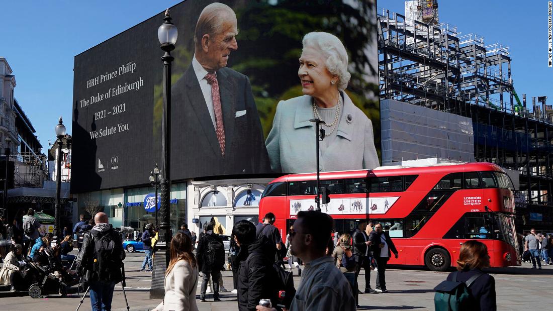 Images of the Queen and Prince Philip are displayed at London&#39;s Piccadilly Circus on Saturday.