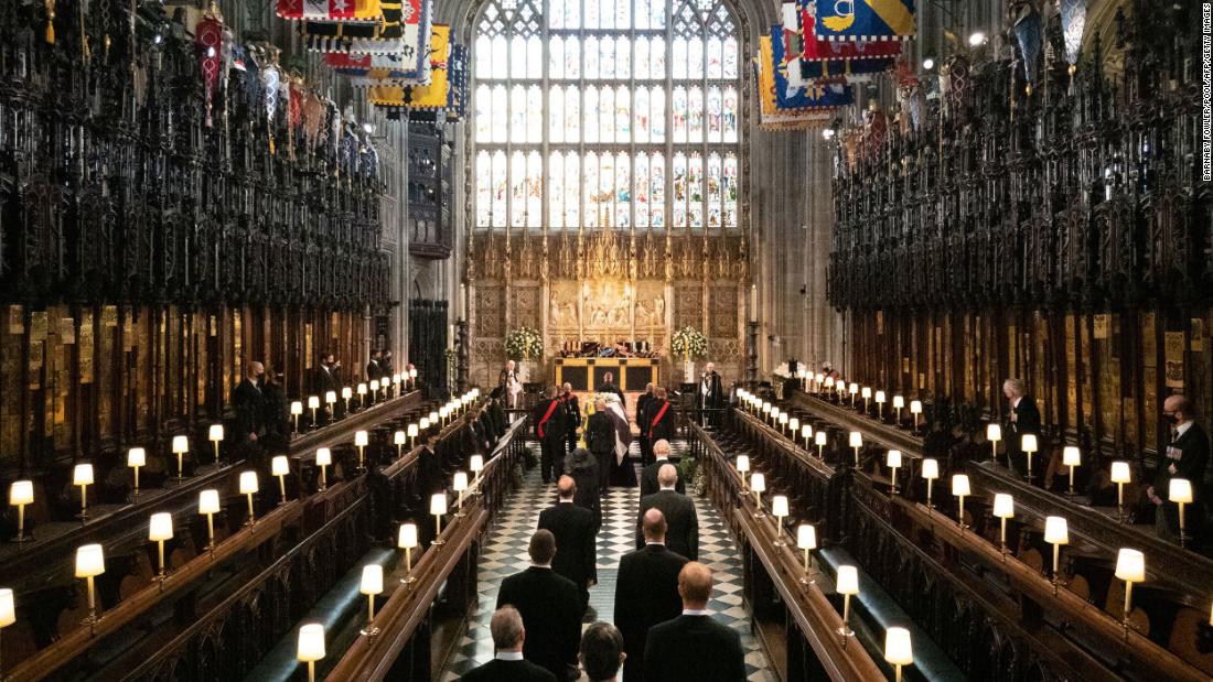 Members of the royal family follow Prince Philip&#39;s coffin into St. George&#39;s Chapel.