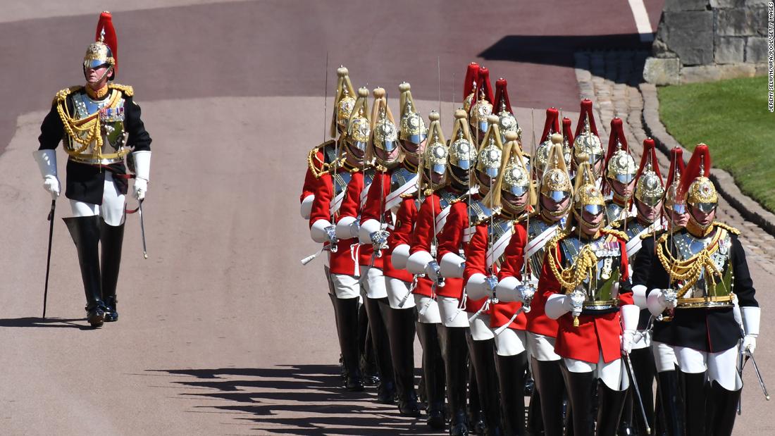 Members of the Household Cavalry march ahead of the funeral service.