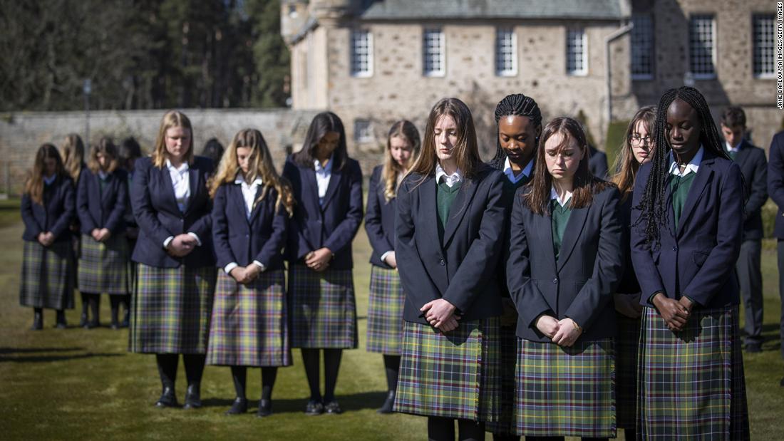 Students from Gordonstoun, Philip&#39;s former school, observe a minute of silence Saturday in Moray, Scotland.