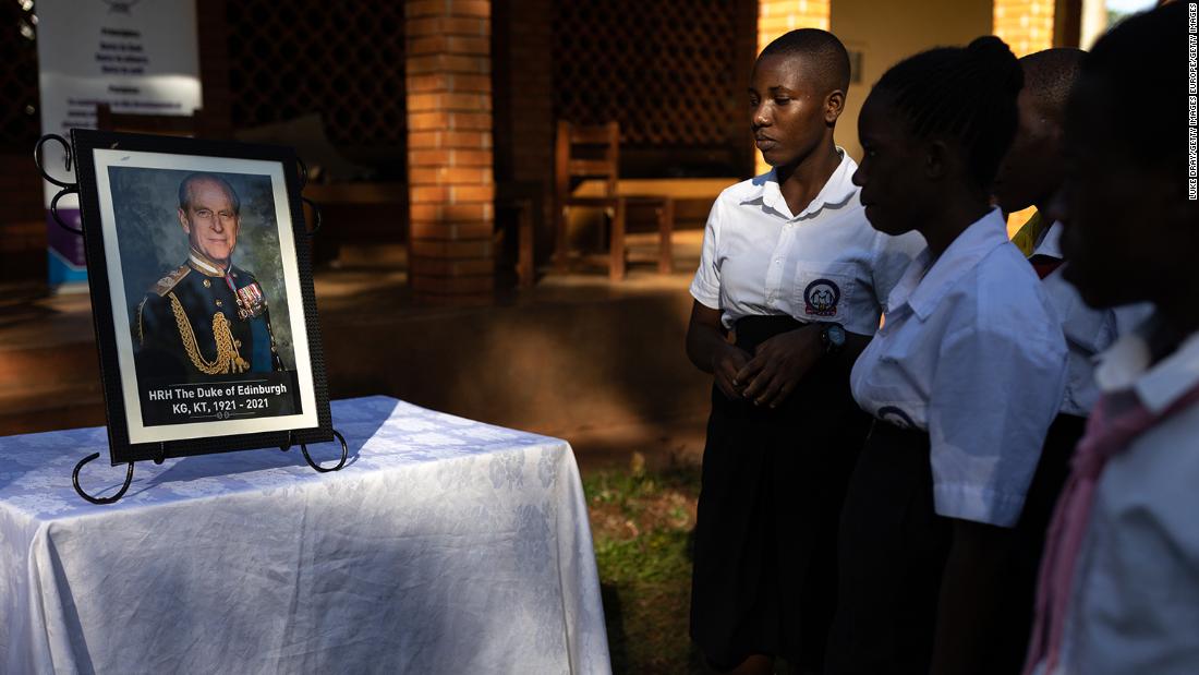 Scouts and Duke of Edinburgh&#39;s Award participants look at a picture of Prince Philip in Jinja, Uganda. 