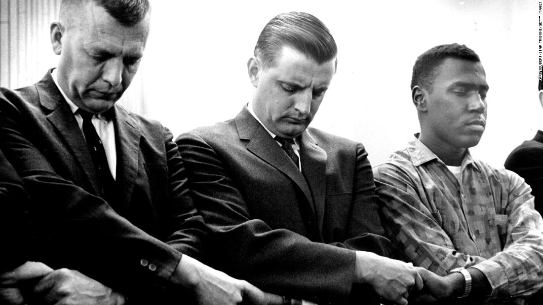 Mondale, center, clasps his hands and bows his head in a prayer line for civil rights demonstrators in Selma, Alabama, in Unity Unitarian Church in St. Paul, Minnesota, on March 11, 1965.