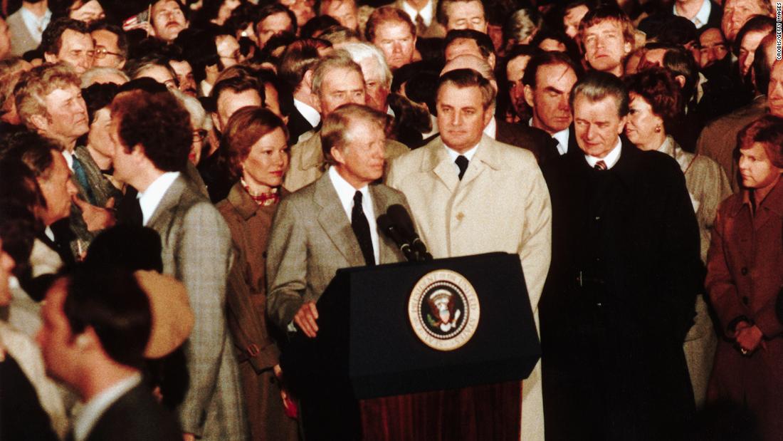 Mondale stands beside President Carter as he gives his concession speech on November 4, 1980, after losing to Ronald Reagan.