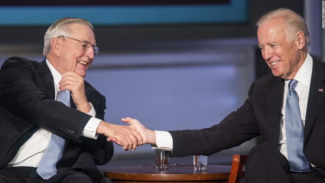 Then-Vice President Joe Biden and Mondale shake hands during an event honoring Mondale at The George Washington University in Washington, DC, on October 20, 2015.