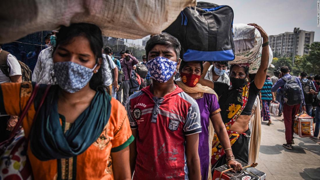 Migrant workers line up at a railway station to leave Mumbai ahead of a lockdown on April 14.