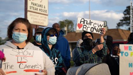 Demonstrators hold signs while participating in a protest march on Thursday in Elizabeth City, North Carolina. 