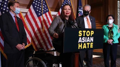 Democrat Sen. Tammy Duckworth, center, speaks during a news conference following the passage of the Covid-19 Hate Crimes Act at the US Capitol on Thursday.