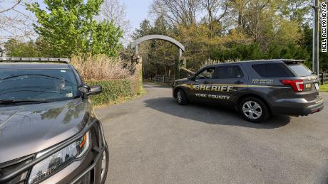 A York County sheriff vehicle drives onto the property where multiple people, including a prominent doctor, were fatally shot on April 7.