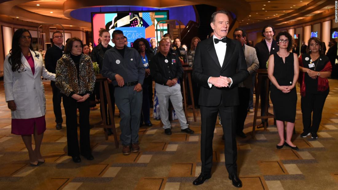Actor Bryan Cranston recognizes some of the vaccinated front-line workers who were at the Dolby Theatre on Sunday night. Cranston was presenting the Jean Hersholt Humanitarian Award to the Motion Picture and Television Fund for the group&#39;s help and assistance to productions during the coronavirus pandemic.