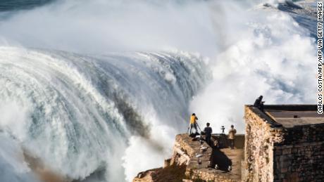 Photographers capture a giant swell at Nazaré last October. 