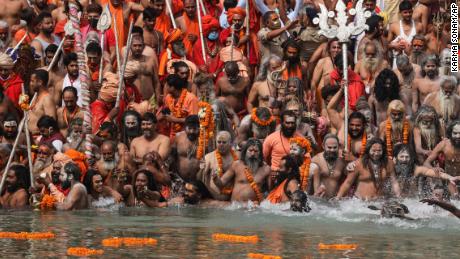 Naked Hindu holy men take dips in the Ganges River during Kumbh Mela, one of the most sacred pilgrimages in Hinduism, in Haridwar, northern state of Uttarakhand, India, on April 12, 2021. 