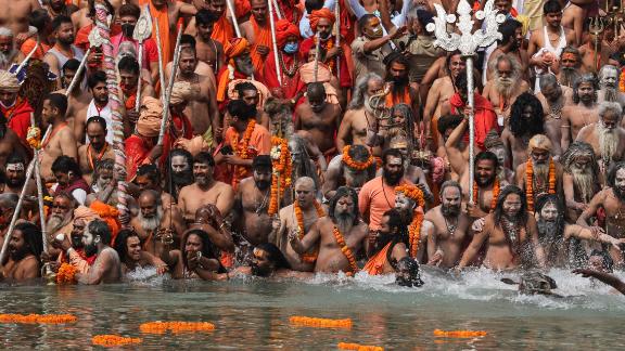 Hindu holy men wade into the Ganges River during the Kumbh Mela religious festival on April 12. People also packed the streets of Haridwar for what is the largest religious pilgrimage on Earth, and the massive crowds created concern.