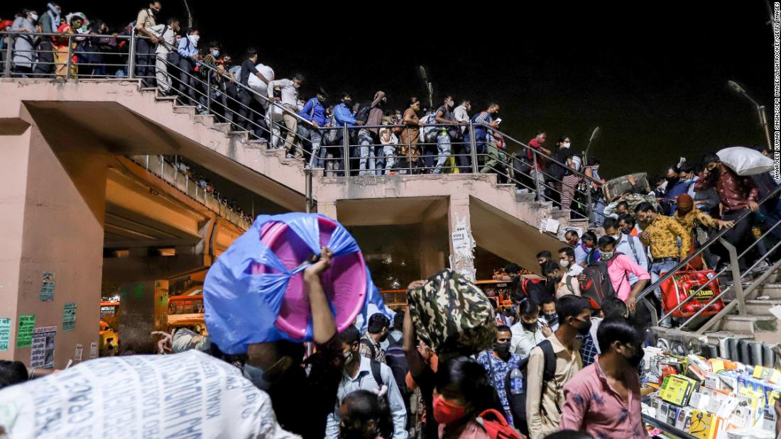 Migrant workers crowd the Kaushambi bus station on April 19. They were trying to return home after a lockdown order was announced in the capital.