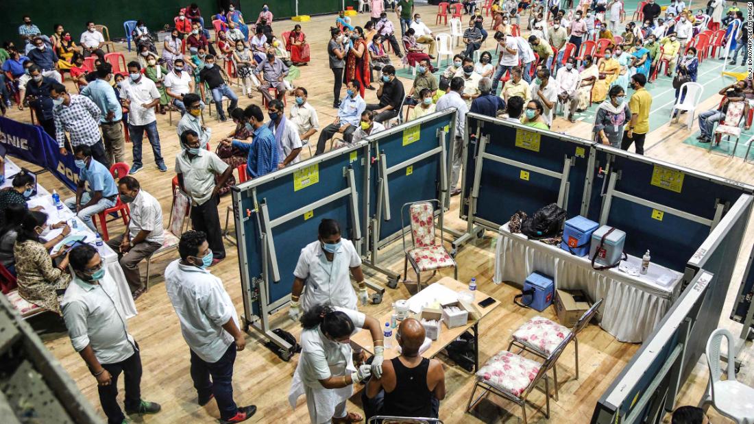 People line up for vaccines at an indoor stadium in Guwahati on April 22.