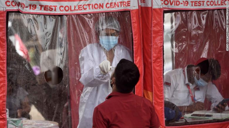 A healthcare worker collects swab samples at a Covid-19 testing center in Mumbai, India, on April 22.