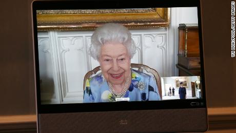 Queen Elizabeth II appears on a screen by video link from Windsor Castle.